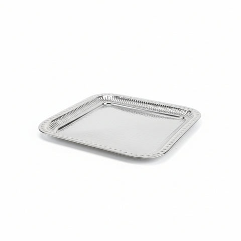 Silver decorative tray on a wooden surface