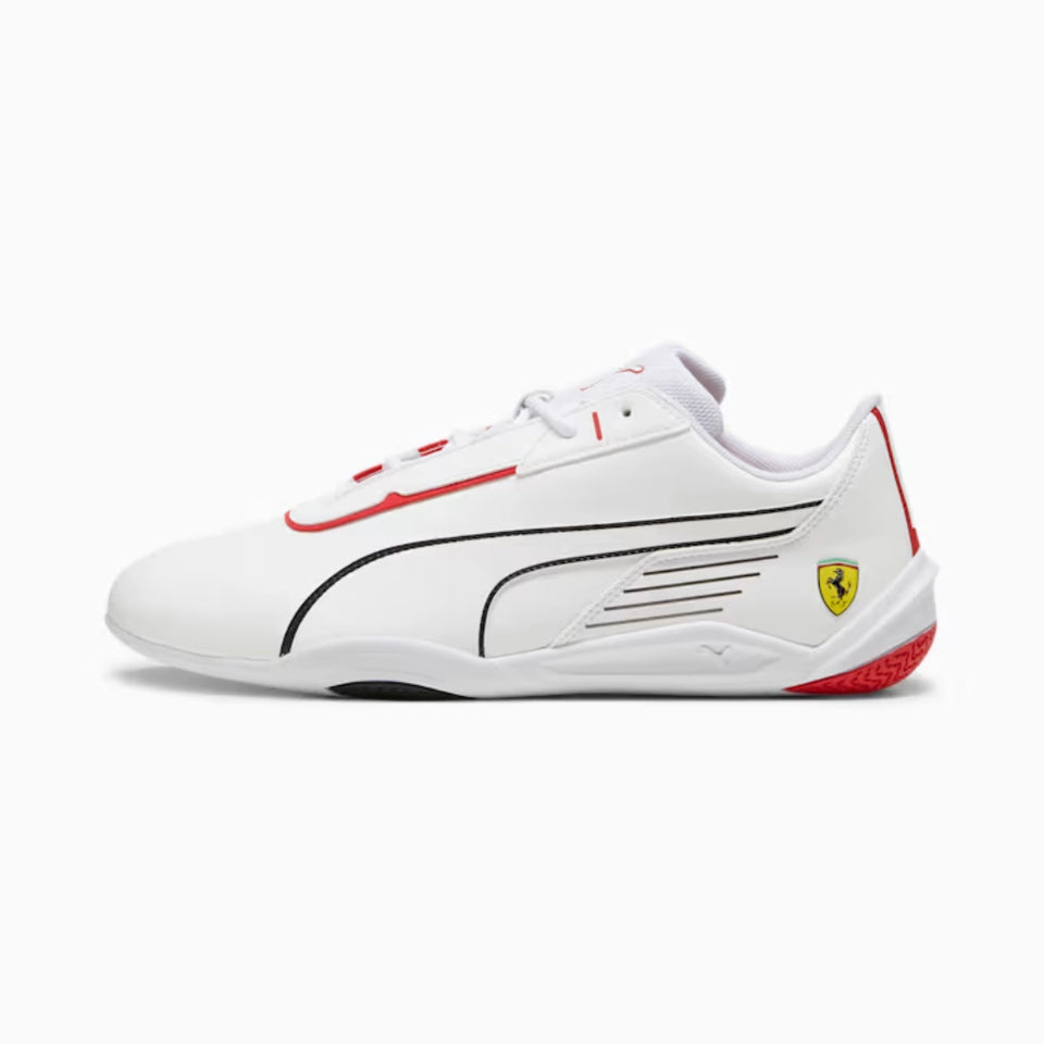 A white Puma Scuderia Ferrari racing shoe with red and black accents, featuring the Ferrari shield logo on the heel, shown against a light gray background.