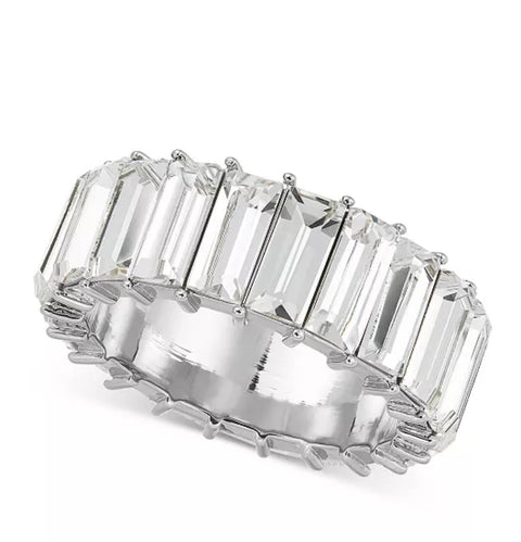 Diamond ring with emerald-cut stones on a white background