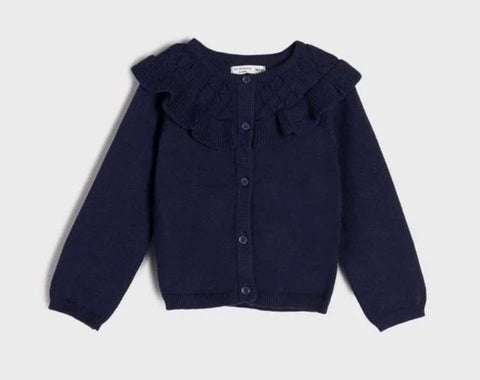 Navy blue cardigan with ruffled shoulders on a light gray background
