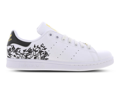 White sneaker with black floral design on a white background