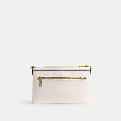White clutch bag with gold zipper on a light gray background
