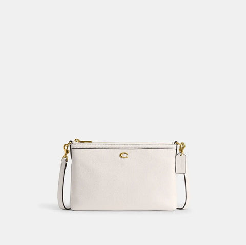 White handbag with gold accents on a light gray background