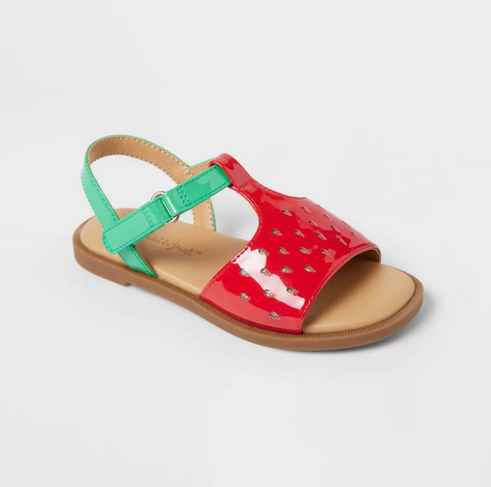 Red sandal with green strap on a light gray background