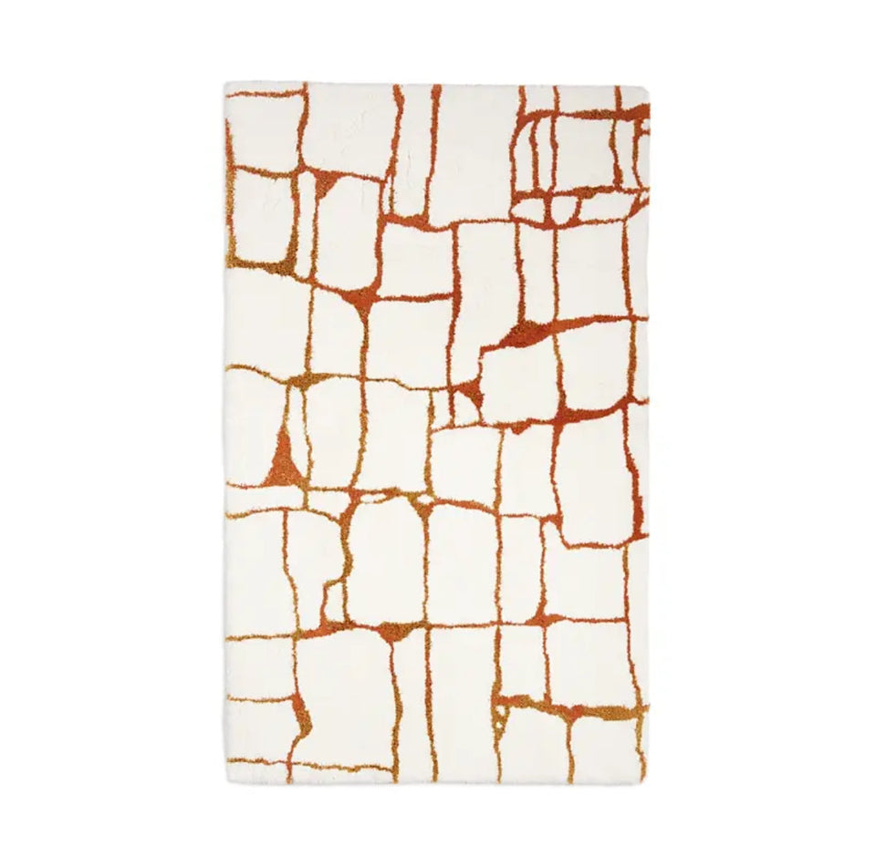 Rectangular mat with a white and orange abstract pattern on a white background