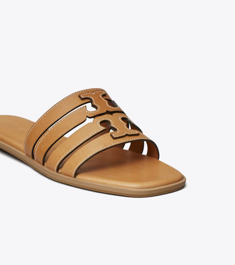 Tan sandal with decorative cut-out design on a white background