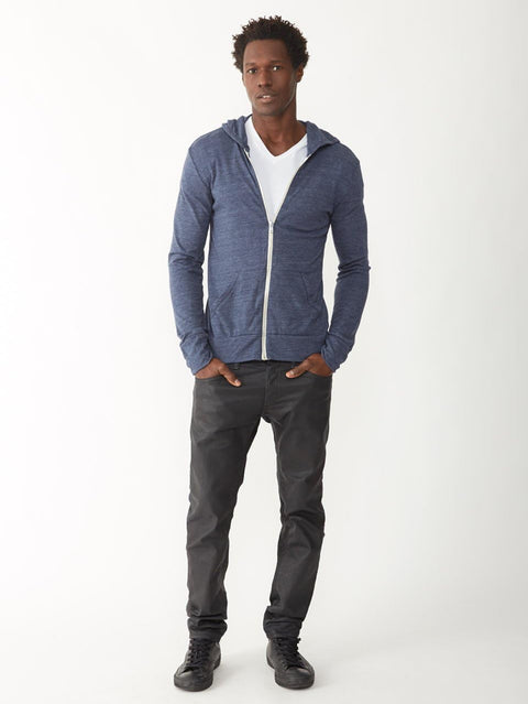 Man wearing a blue hoodie, white shirt, and dark pants on a white background