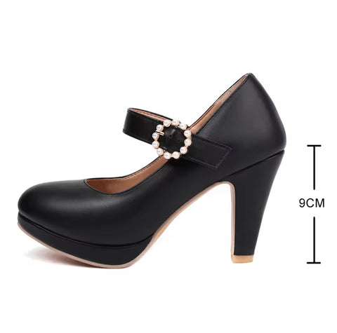 Black high-heeled shoe with pearl strap on a white background