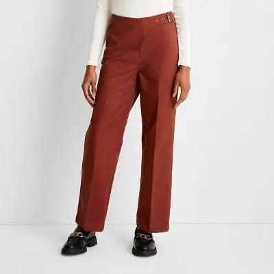 Brown pants worn by a person on a white background