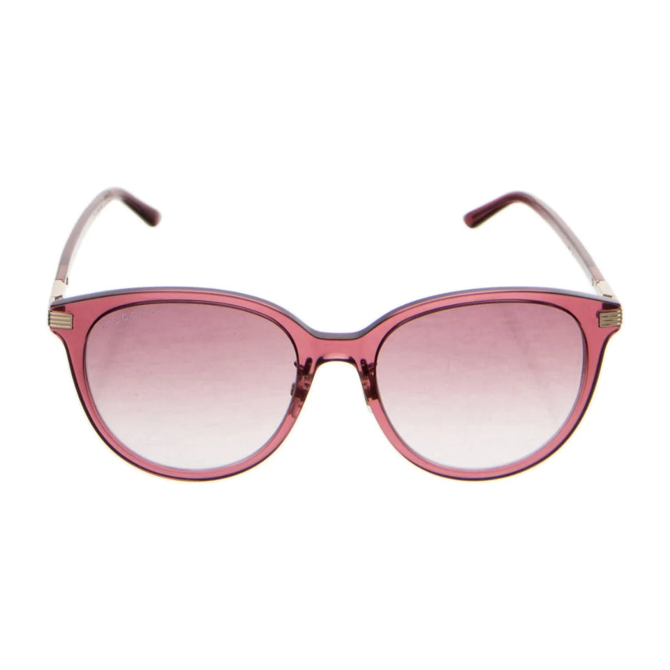 Oversized cat-eye sunglasses with a translucent pink frame and matching pink gradient lenses, shown against a plain white background.