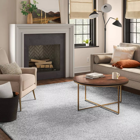 Living room with a fireplace, sofa, and coffee table.