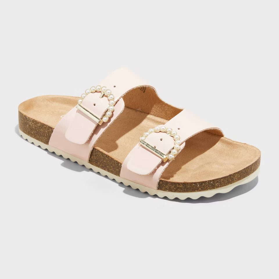 Pink sandal with pearl embellishments on a light gray background