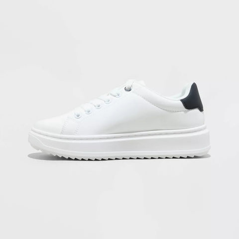 White sneaker with a black heel tab on a light gray background