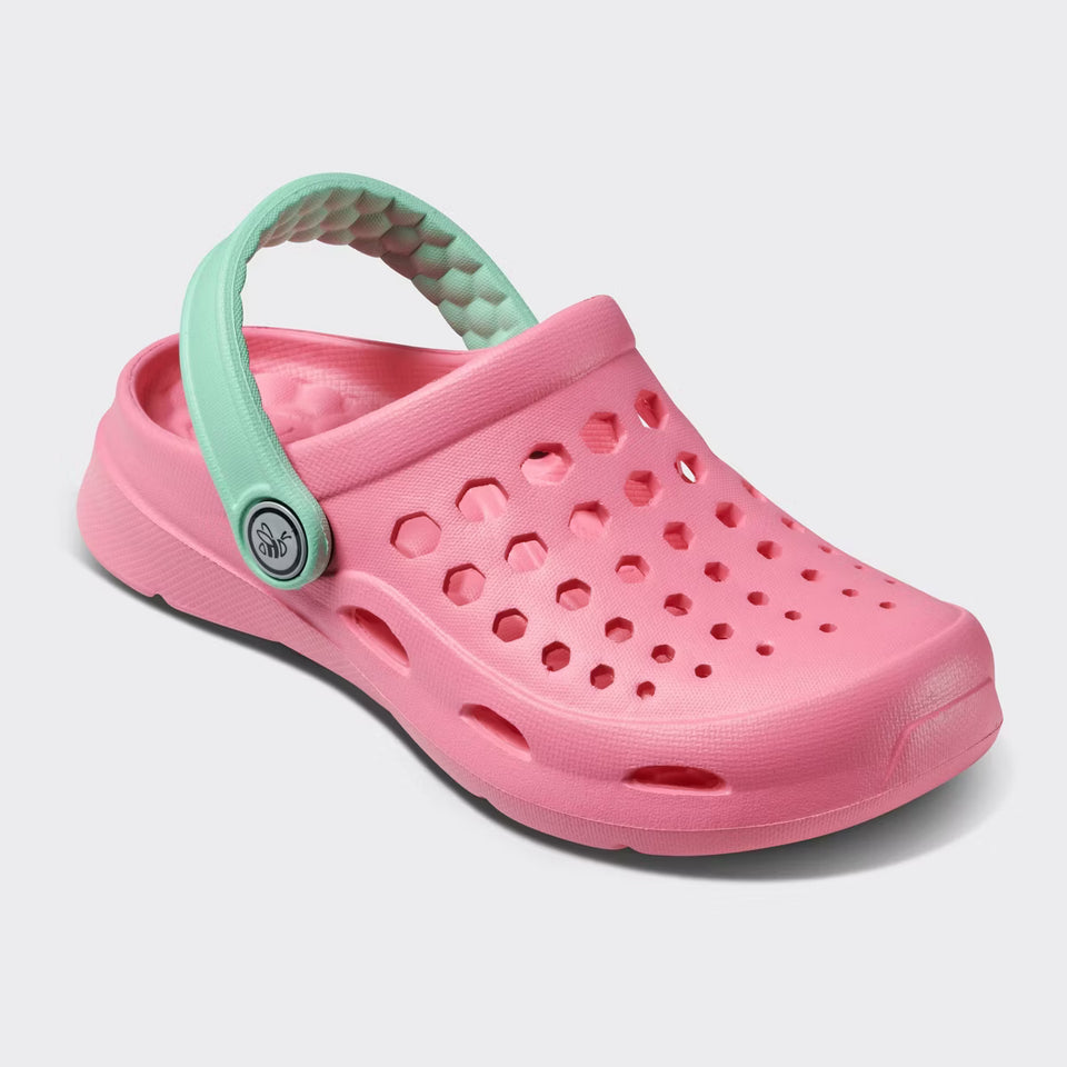 Pink clog shoe with a green strap on a light gray background