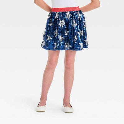 Person wearing a blue floral skirt on a white background