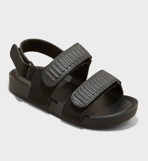 Black sandal with two straps on a light gray background