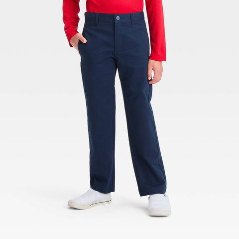 Person wearing navy pants with a red shirt on a white background