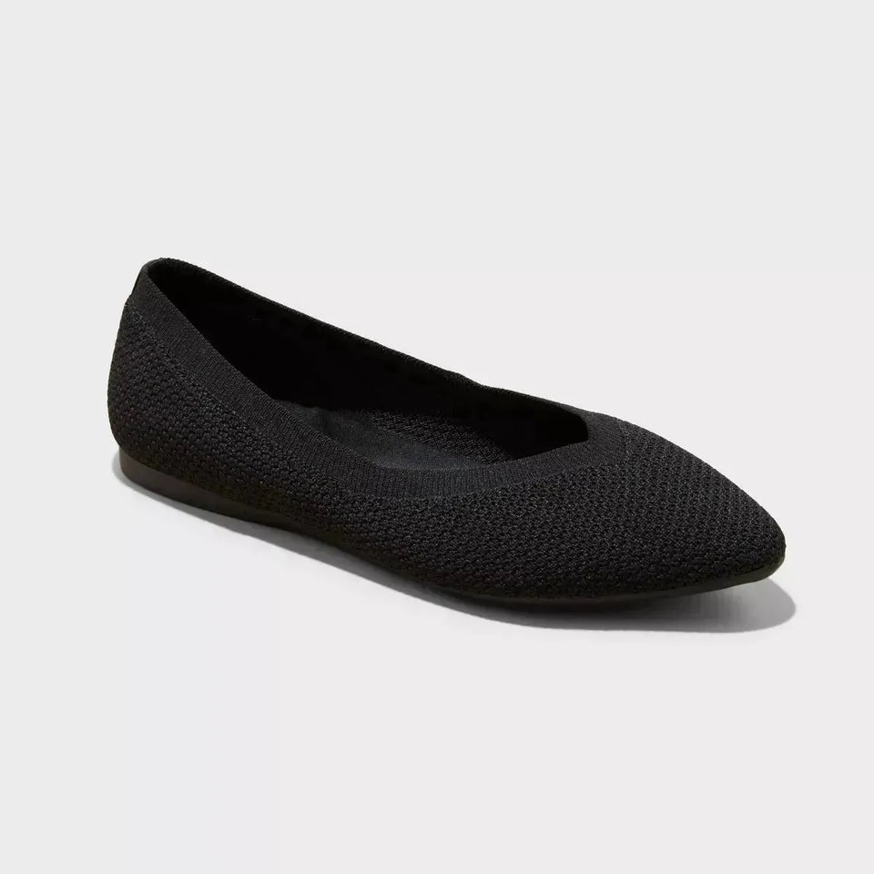 Black flat shoe on a light gray background