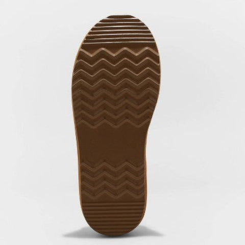 Close-up of a brown shoe sole with wavy pattern on a light gray background
