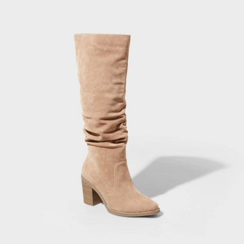 Beige knee-high boot on a light gray background