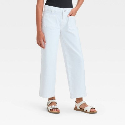 Person wearing white pants on a plain background