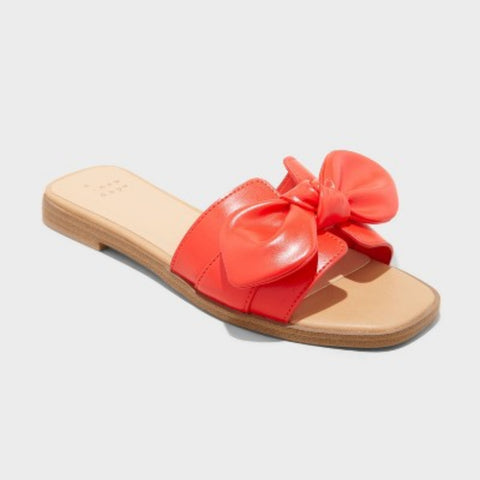 Red slide sandal with a bow on a light gray background