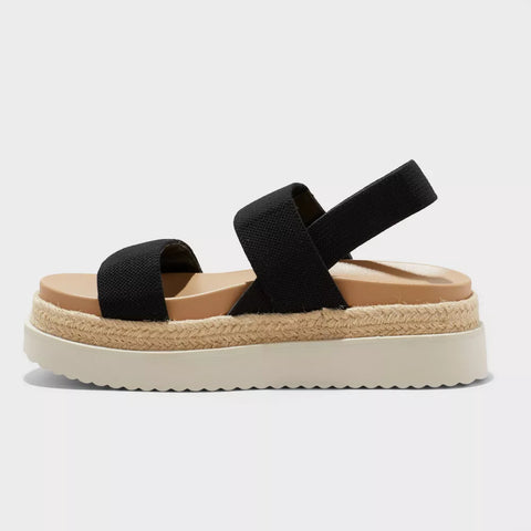 Black sandal with a woven sole on a white background
