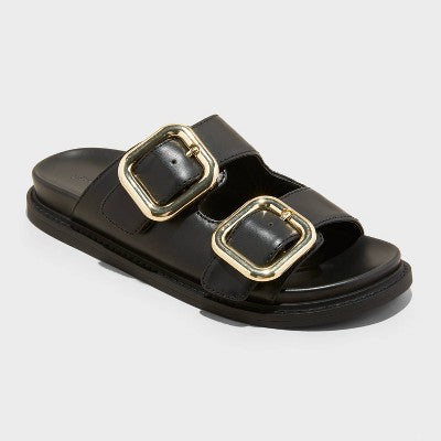 Black sandal with gold buckles on a white background