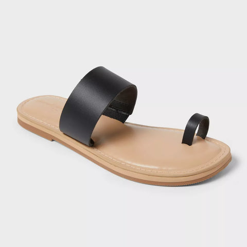 Black sandal with a beige sole on a light gray background