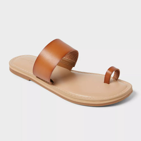 Tan sandal with a brown strap on a light gray background
