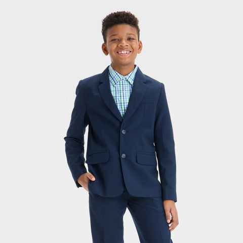 Young boy wearing a navy suit with a white background