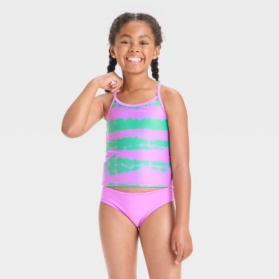 Young girl wearing a colorful swimsuit on a white background