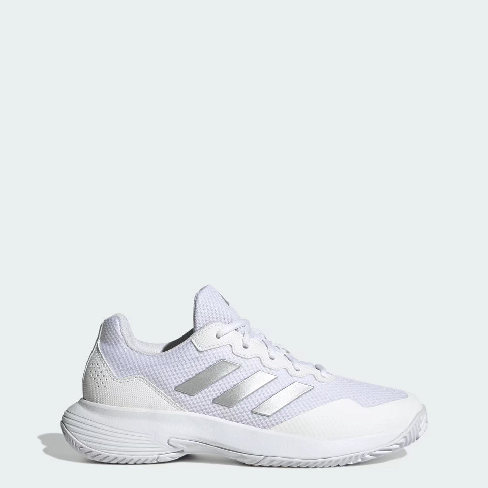 A white Adidas athletic shoe with metallic silver stripes, shown from a side profile on a light gray background.