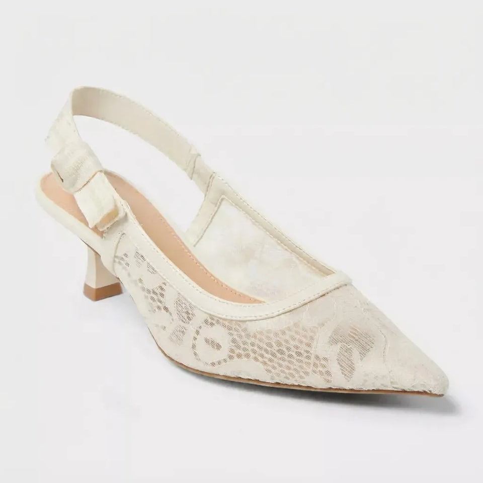 An off-white pointed-toe slingback kitten heel shoe with a textured lace overlay and a beige block heel, shown against a plain white background.