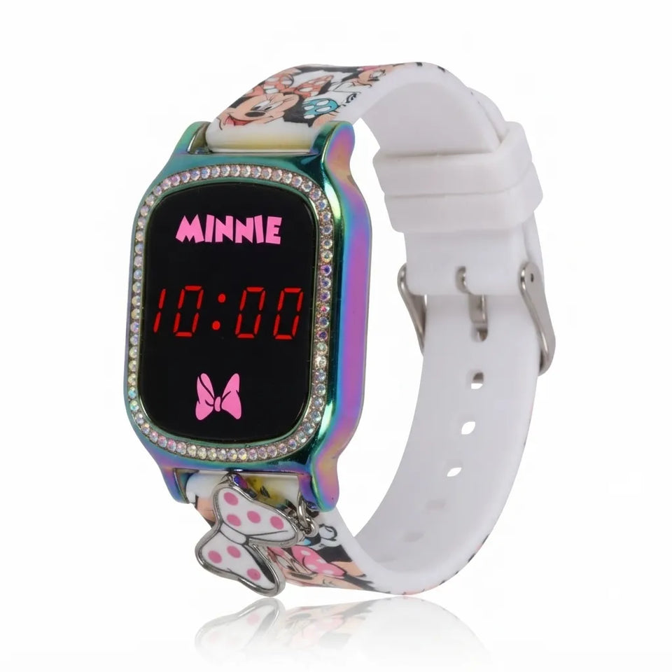 A Minnie Mouse digital kids watch with a white silicone strap, a colorful iridescent face, rhinestone trim, and a pink Minnie logo on the display.