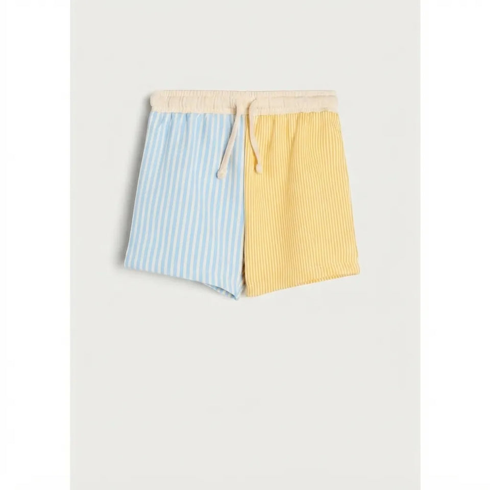 A pair of men's casual shorts with a split design, featuring light blue and white vertical stripes on one leg and a textured yellow vertical stripe pattern on the other. The shorts have an elastic waistband with a cream-colored drawstring.