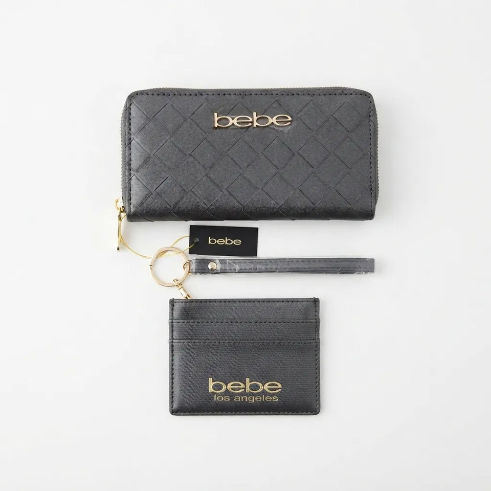 A black quilted leather wallet set with a wristlet strap and card holder, both featuring gold-tone 'bebe los angeles' branding, displayed on a clean white background.