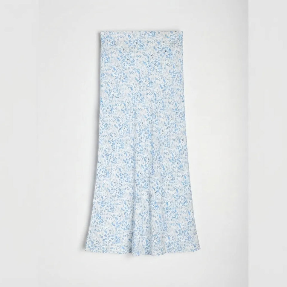 A light blue and white floral print midi skirt with a flared silhouette, displayed flat against a clean white background.