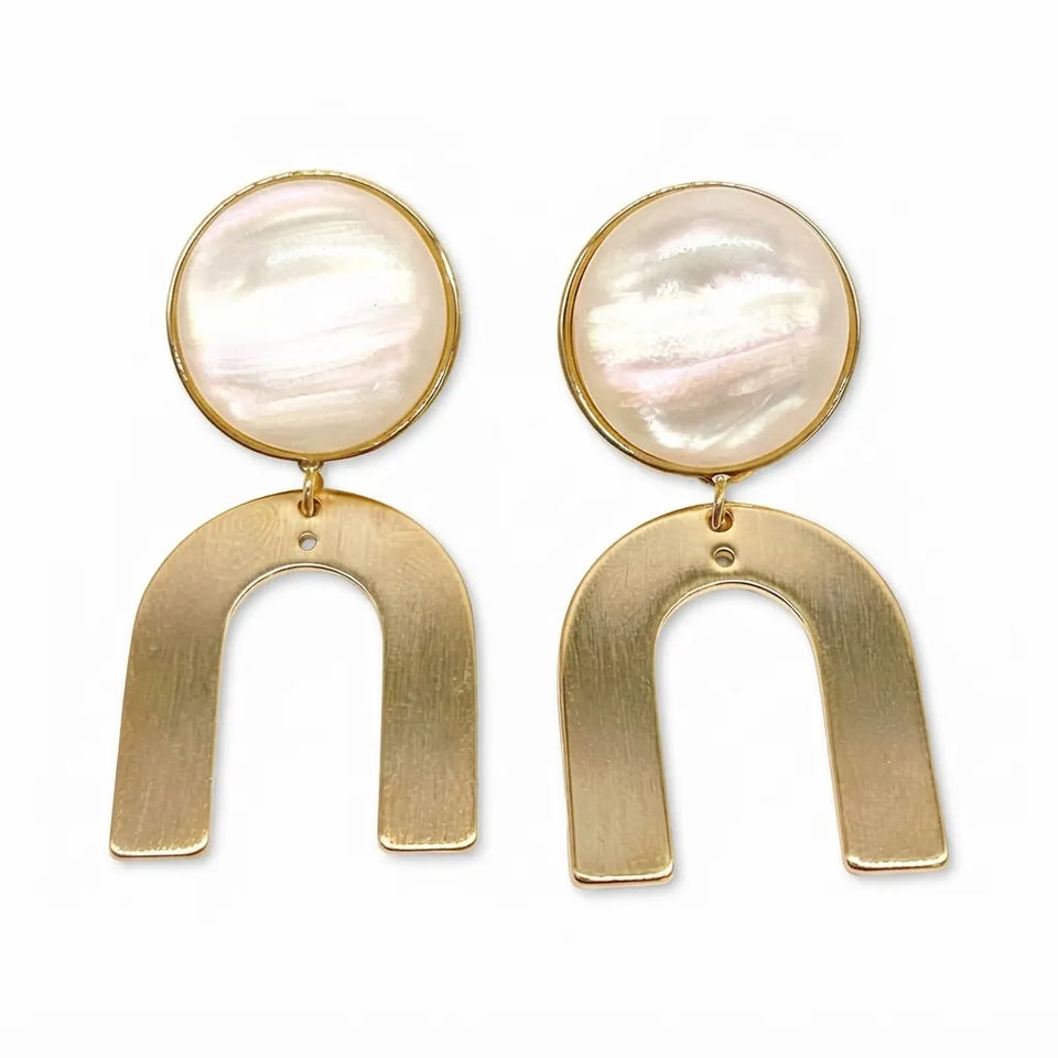 A pair of gold-tone drop earrings featuring a round, iridescent mother-of-pearl disc at the top and a wide, open U-shaped gold-tone metal piece hanging below, set against a plain white background.
