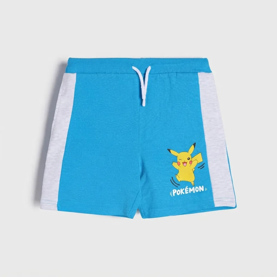 Blue athletic shorts with white side panels, a white drawstring, and a yellow Pikachu graphic with the word 'POKEMON.' on the lower right leg, shown on a light gray background.