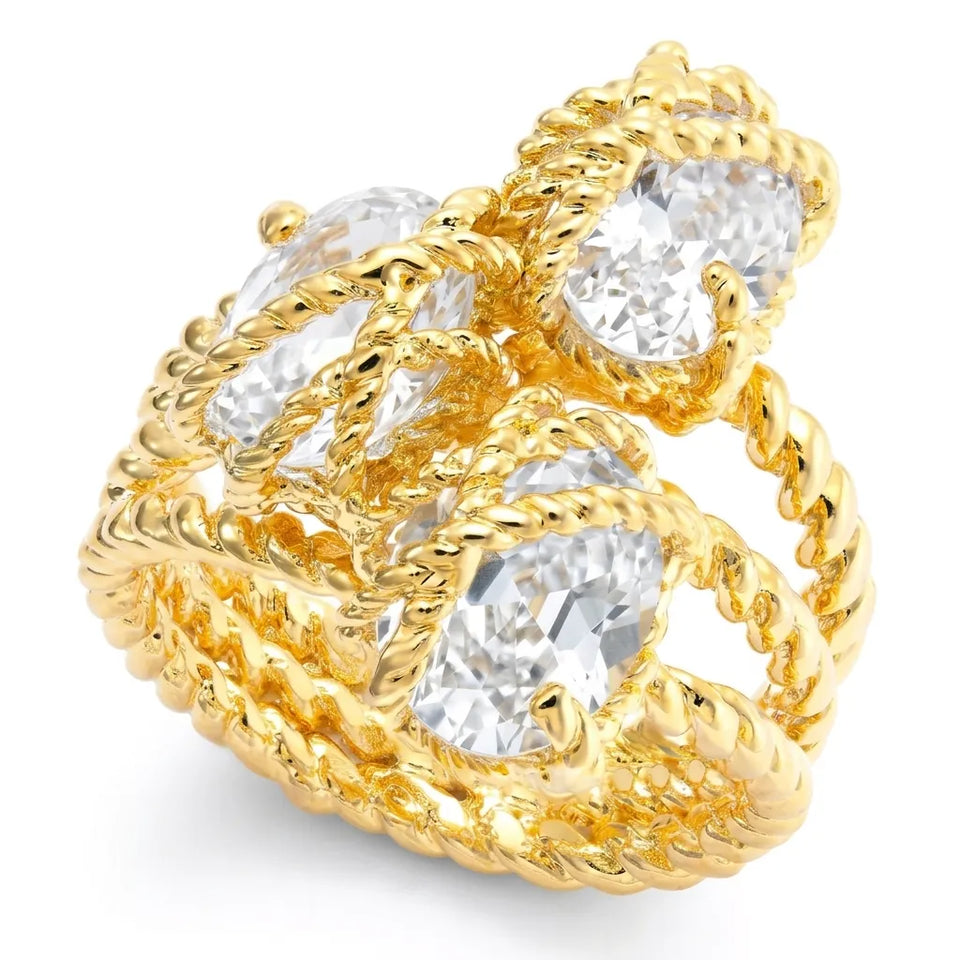 A gold ring featuring multiple large clear marquise and oval-cut gemstones set in a twisted rope-style gold band, photographed on a clean white background.