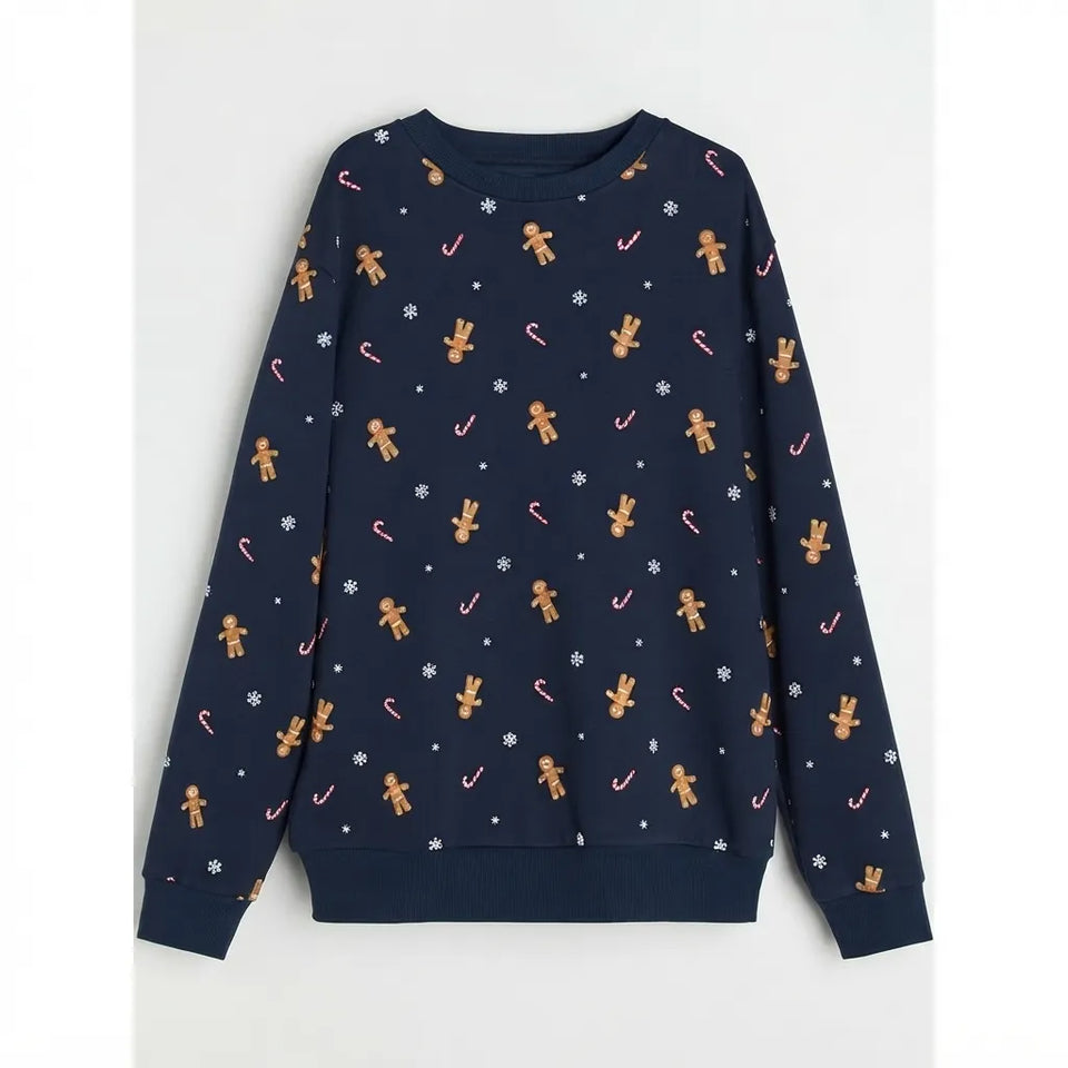 A navy blue long-sleeve crewneck sweatshirt featuring an all-over Christmas print of gingerbread men, candy canes, snowflakes, and white stars, displayed flat against a light gray background.