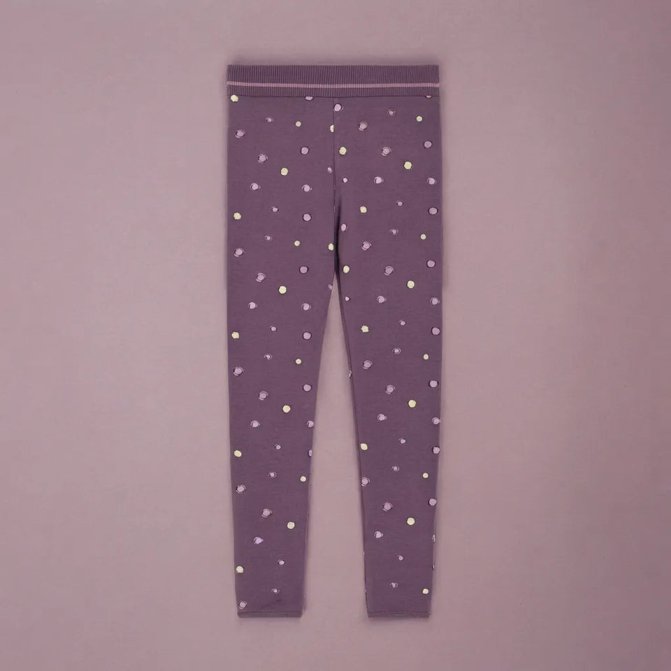 Purple leggings with a small multicolor polka dot pattern, laid flat against a matching light purple background.