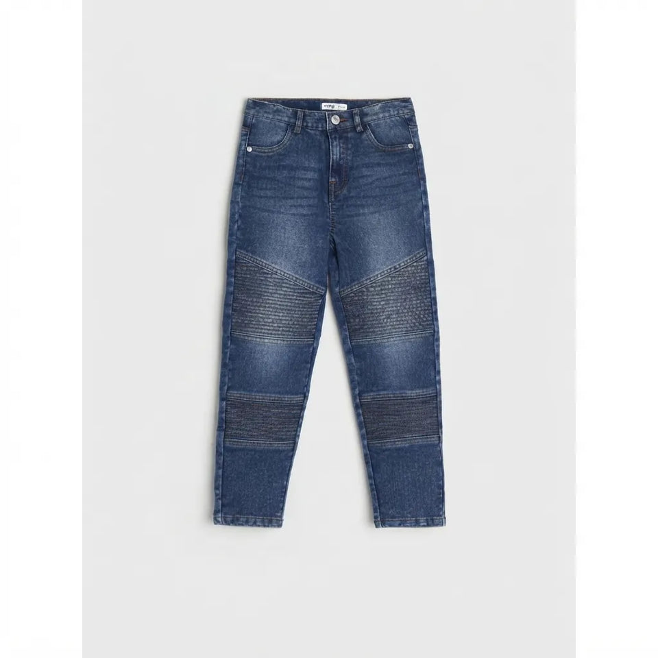 A pair of dark blue denim jeans with textured, ribbed patch panels on the thighs and lower legs, displayed flat against a light gray background.