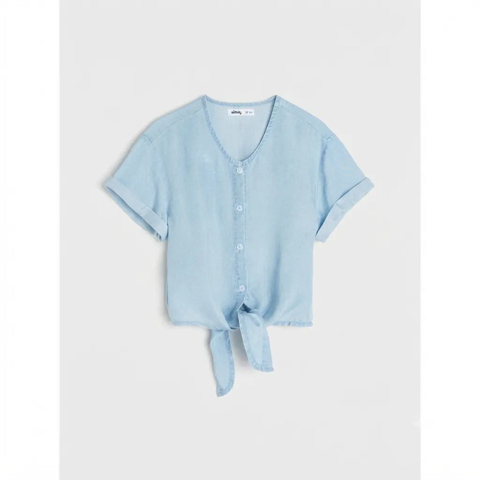 A light blue short-sleeve button-front top with a V-neck and a tied knot at the hem, displayed flat against a light gray background.