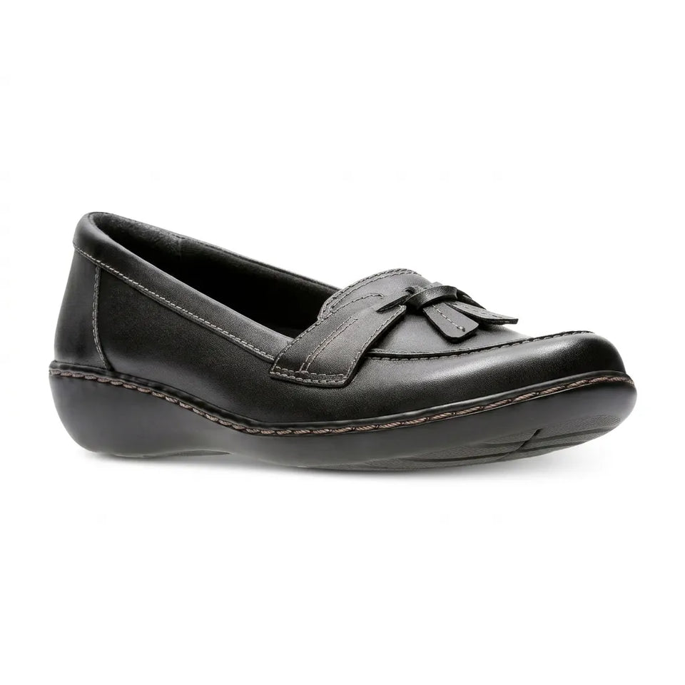 A single black leather slip-on loafer with a tassel detail on the strap, shown from a side profile against a plain white background.