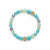 A beaded stretch bracelet featuring light blue faceted beads, pale mint green matte beads, and two gold-toned decorative floral beads with clear rhinestones, displayed on a clean white background.
