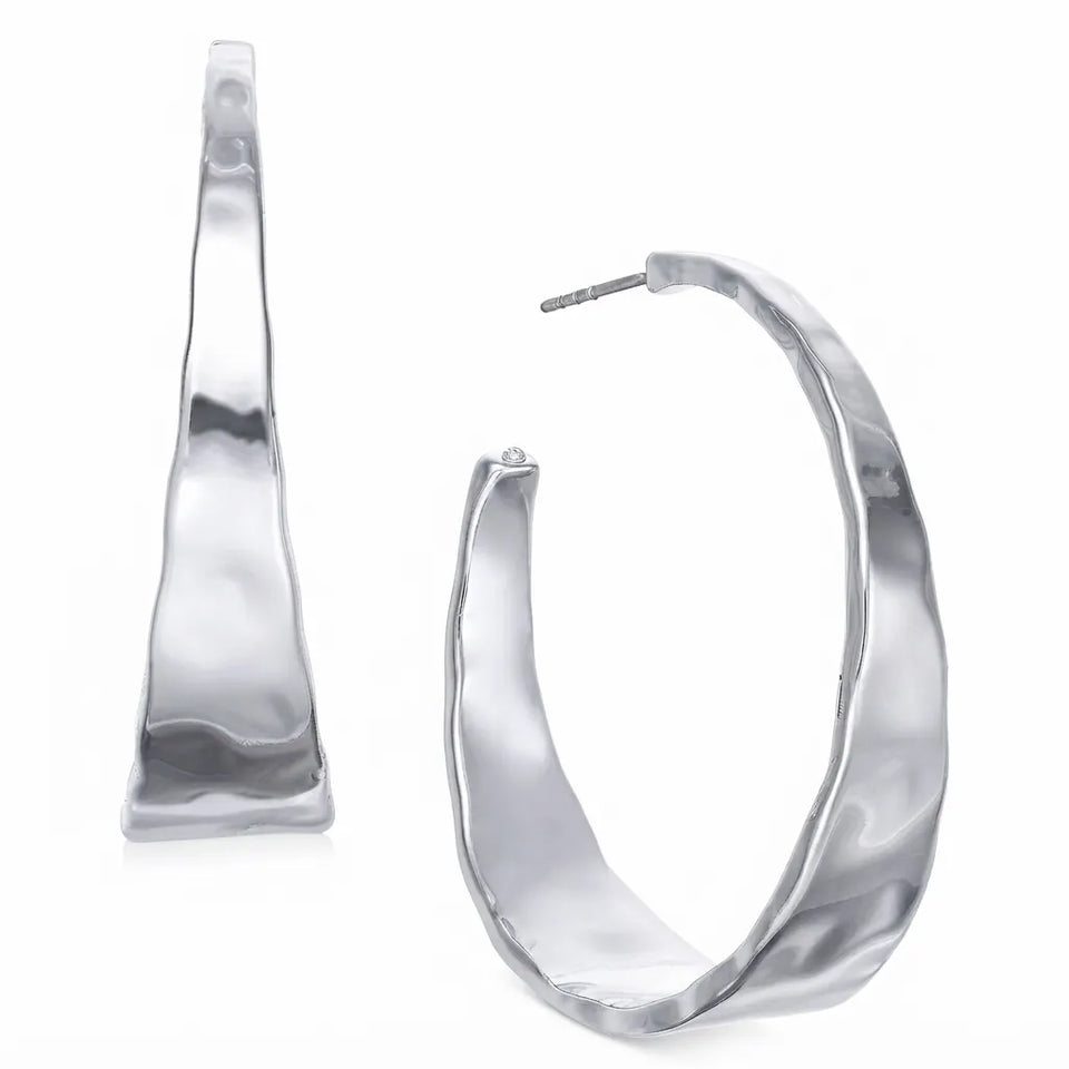 A pair of large, wavy, hammered silver hoop earrings shown on a clean white background, displaying both the front face and the side profile with post.