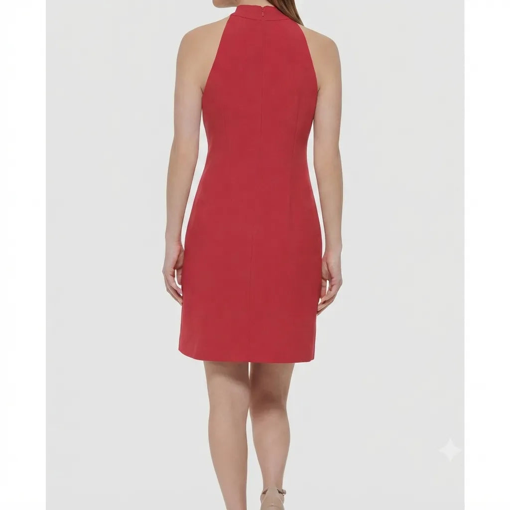 A woman wearing a sleeveless red halter-neck dress, shown from the back against a light gray studio background.