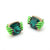 A pair of gothic-style stud earrings featuring a large faceted dark green gemstone held by two small green skeletal hands with pink fingernails, set in gold-tone metal on a white background.